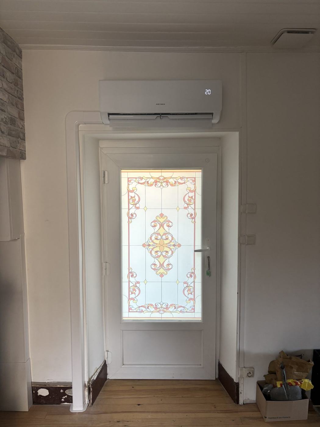 Climatisation murale installée au-dessus d'une porte